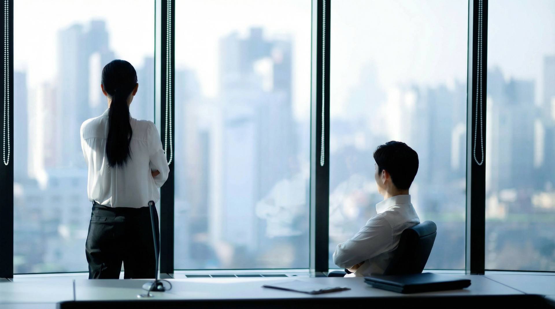 Business professionals in modern office overlooking city skyline - NeoSapiens Executive Search